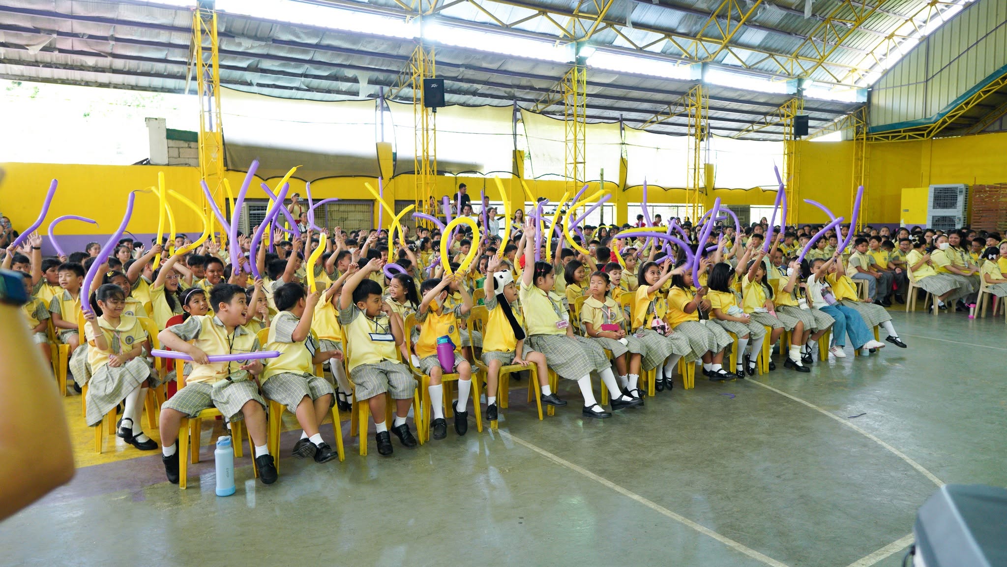 NSDGA students celebrating together with purple and yellow balloons